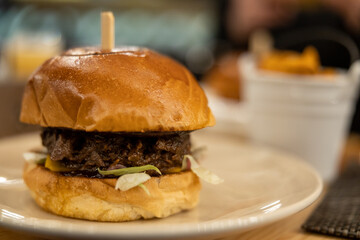 Big hamburguer over reastaurant table