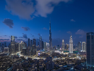 Aerial view of the skyline in Dubai Downtown after sunset during the blue hour. Dubai, United Arab Emirates.