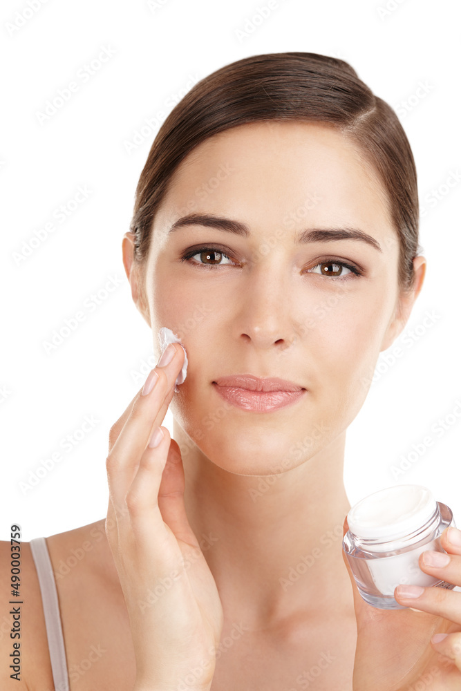 Wall mural You should try this. Cropped portrait of a beautiful young woman applying moisturizer against a white background.