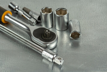 Auto mechanic's tools on a gray metal table. Close-up on a gray background