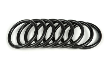 Hydraulic and pneumatic o-rings in black in different sizes on a white background. Various seals for plumbing. Sealing rings for hydraulic connections.