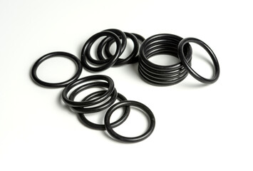 Hydraulic and pneumatic o-rings in black in different sizes on a white background. Various seals for plumbing. Sealing rings for hydraulic connections.