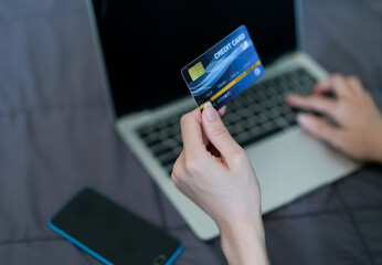 Hand woman holding credit card for shopping online.  Technology and modern business