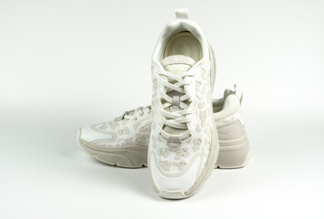 Pair of trendy sneakers on a white background. Close-up