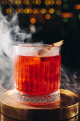 Classic old fashioned Cocktail in a retro glass with smoke