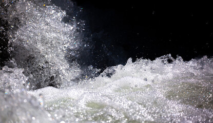 Drops of water, splashing and bubbling waterfall as a background. Foam party or laundry. The concept of freshness of soft drinks.
