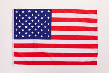 Closeup studio isolated top view shot of pride patriotism blue and red striped star American nation USA United States of America country national fabric clothing unity flag placed on white background