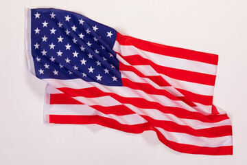 Closeup studio isolated top view shot pride patriotism blue and red striped star American nation USA United States of America country national fabric clothing unity rippled flag on white background