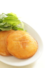 Asian food, deep fried sticky rice cake served with baby leaves with copy space