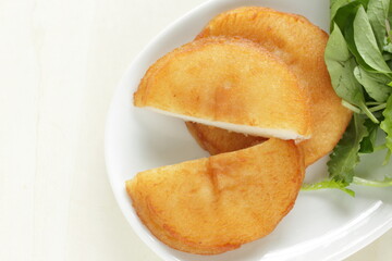 Asian food, deep fried sticky rice cake served with baby leaves with copy space