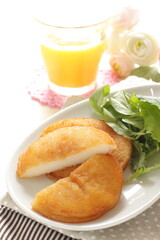 Asian rice cake served with salad and orange juice for cafe style food image