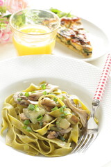 Homemade Italian food, eggplant and mushroom with spinach fettuccine serving with sesame bread