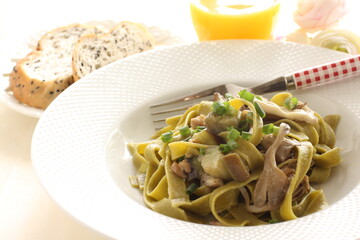 Homemade Italian food, eggplant and mushroom with spinach fettuccine serving with sesame bread