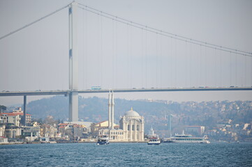 Fototapeta na wymiar Istanbul / Turkey - 02.28.2017 : Coastal zone and architecture of the Bosphorus Strait. A bridge connecting Europe and Asia.