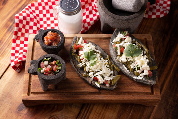 Tlacoyos with Nopales and Cheese. Mexican pre hispanic dish made of blue corn flour patty filled with refried beans. Popular street food in Mexico.