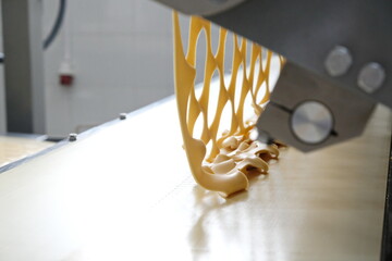 Shymkent, Kazakhstan-03.12.2020: Rakhat confectionery factory. Cutting out shaped cookies from the dough.