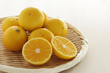 Fototapeta na wymiar Japanese Shonan Golden mandarin orange on bamboo basket