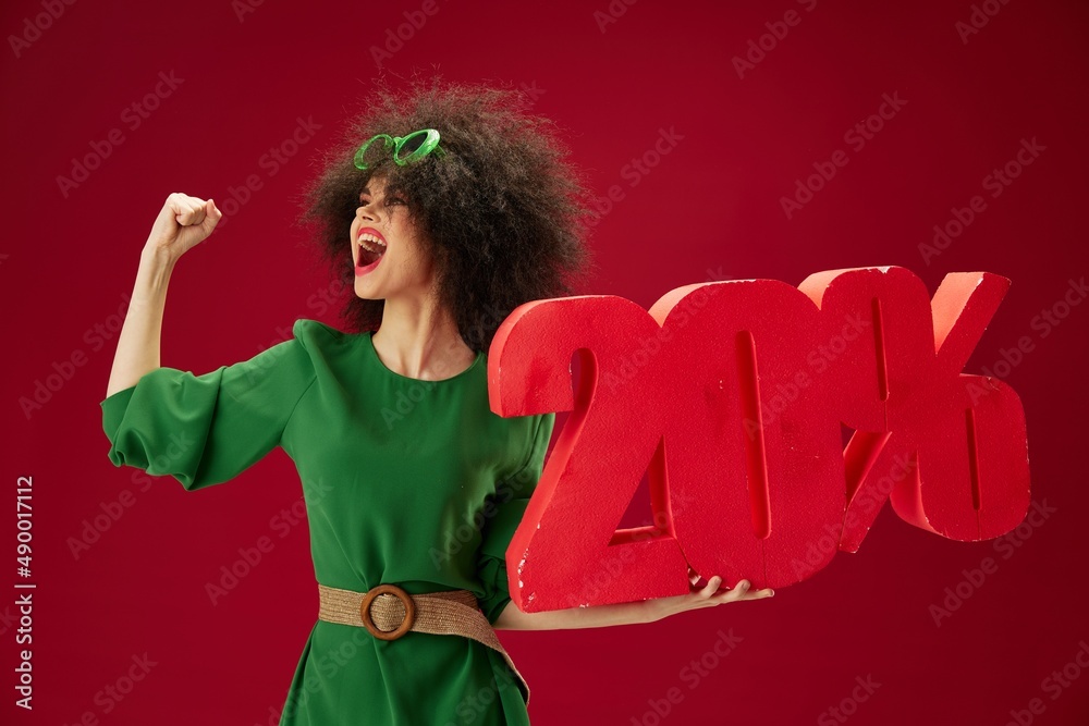 Canvas Prints Pretty young female green dress afro hairstyle dark glasses twenty percent in hands color background unaltered