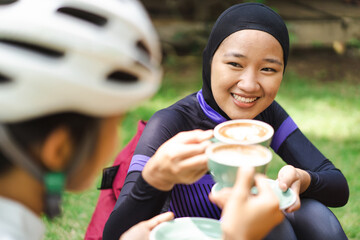 muslim road bike cyclist sitting in a coffee shop having a break