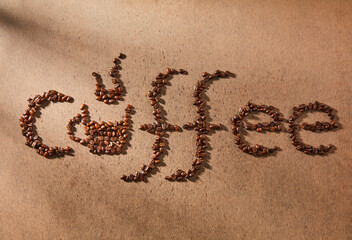 Image of the word coffee written in whole coffee beans