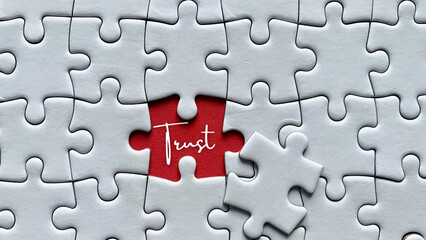 Fototapeta premium Jigsaw puzzle with a word Trust. Business and working relationship concept