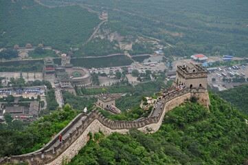 Beijing / China - 08.05.2012 : Tourists from all over the world walk part of the way along the great wall of China. Views of mountains and hills.