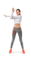 Young sporty woman exercising on white background