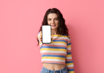 Naklejka premium Beautiful brunette woman with mobile phone on pink background