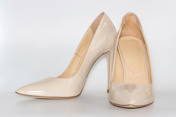 Front view of the nude colored high heeled women's shoes.