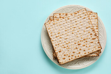 Plate with Jewish flatbread for Passover on color background