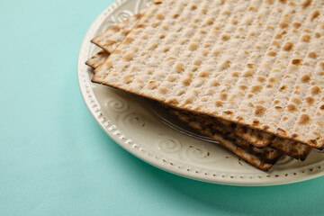 Plate with Jewish flatbread for Passover on color background, closeup