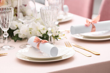 Stylish table setting with wedding invitations