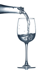 Pouring of clear water in glass isolated on white