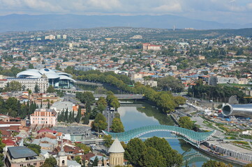 Fototapeta na wymiar Tbilisi / Georgia - 10.26.2012 : View from the hill of residential buildings, religious sites and buildings in the city center.