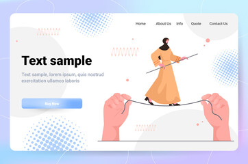 arab business woman walking on balancing tight rope risk challenge help in business concept horizontal