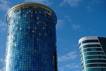 Fototapeta premium Nur-Sultan / Kazakhstan - 10.01.2020 : Multi-storey office buildings with blue-green glass Windows in the center of the capital.