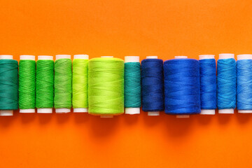 Thread spools on orange background