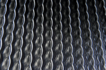 shiny metallic waves of bent metal. aluminum stamping in production