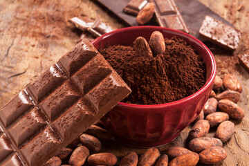 Chocolate bars, cacao beans and cacao powder are together. - 490026770
