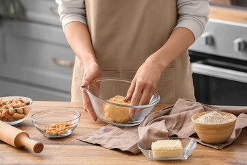 Obraz na płótnie Canvas Woman preparing peanut cookies at kitchen table, closeup