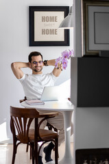 Man working at home using laptop.