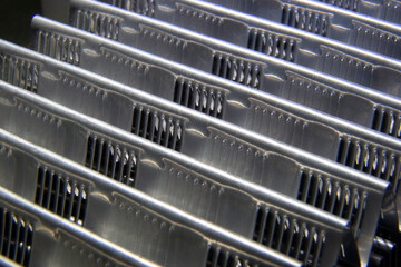 shiny metallic waves of bent metal. aluminum stamping in production