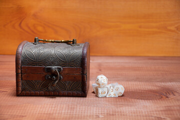 Set of role playing white dices   lie about wooden storage box, concept for playing role-playing game on wooden background with space of text