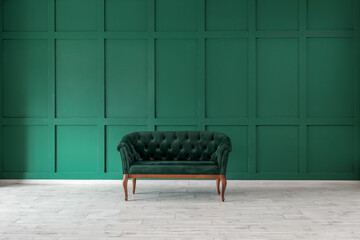 Stylish sofa near green wall