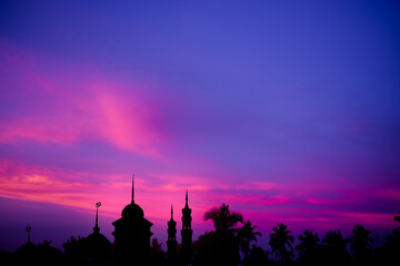 Naklejka premium Ramadan, Eid ai-fitr,New year Muharram islamic religion Symbols with Mosques Dome silhouette on dark blue and pink purple twilight sky in night sunset. arabic,Eid al-adha,mubarak Muslim concept.