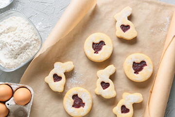 Parchment paper with tasty Easter cookies on table