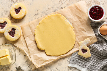 Fresh dough and ingredients for preparing Easter cookies on beige background