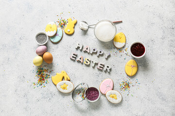 Text HAPPY EASTER made of wooden letters, cookies, sprinkles and painted eggs on light background