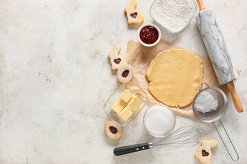Fototapeta na wymiar Fresh dough and ingredients for preparing Easter cookies on light background