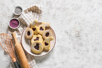 Plate with homemade Easter cookies on light background